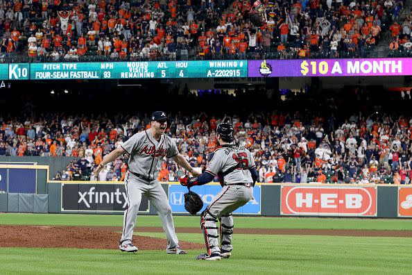 HOUSTON, TEXAS - NOVEMBER 02:  Will Smith #51 and Travis d'Arnaud #16 of the Atlanta Braves celebrate the team's 7-0 victory against the Houston Astros in Game Six to win the 2021 World Series at Minute Maid Park on November 02, 2021 in Houston, Texas. (Photo by Carmen Mandato/Getty Images)