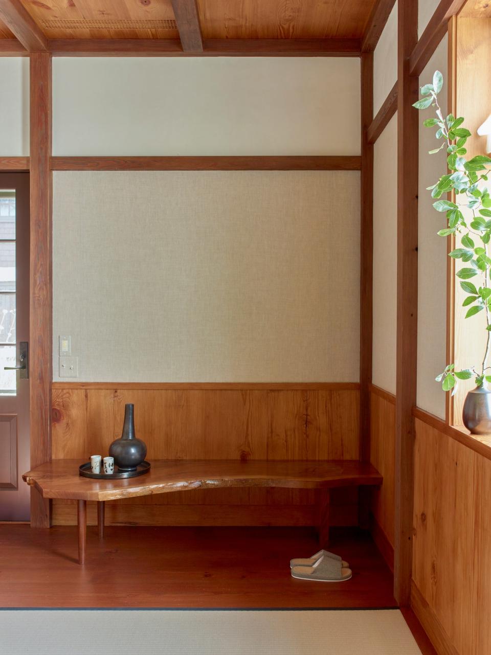 Inset linen panels echo traditional Japanese shoji screens; bench by George Nakashima Woodworkers.