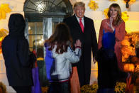 President Donald Trump and first lady Melania Trump greet trick-or-treaters on the South Lawn during a Halloween celebration at the White House, Sunday, Oct. 25, 2020 in Washington. (AP Photo/Manuel Balce Ceneta)