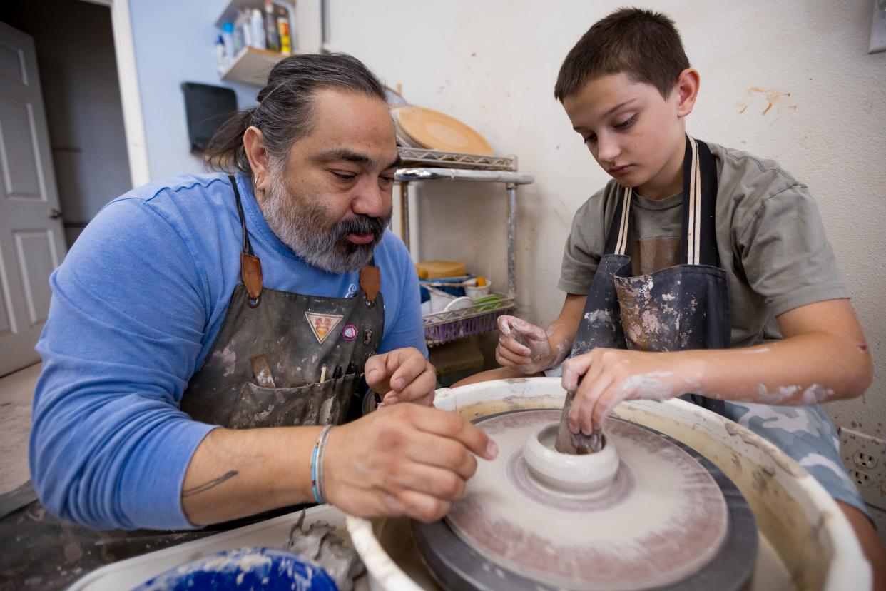 Philip John "PJ" Romero teaches Mateo Stopani at his ceramics studio, PJ Romero Artworks, 120 S. Carolina Dr. in El Paso, TX, on Tuesday, June 18, 2024.