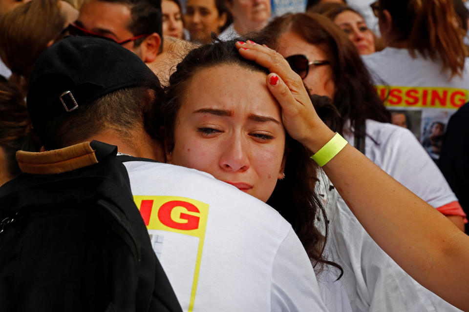 People react near the scene of the fire