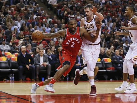 Oct 17, 2018; Toronto, Ontario, CAN; Toronto Raptors forward Kawhi Leonard (2) drives to the net against Cleveland Cavaliers forward Kevin Love (0) at Scotiabank Arena. Toronto defeated Cleveland. Mandatory Credit: John E. Sokolowski-USA TODAY Sports