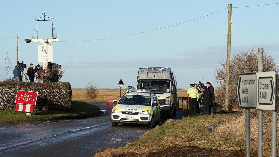 Police vehicles parked at Cley Marshes after a helicopter crash in 2014