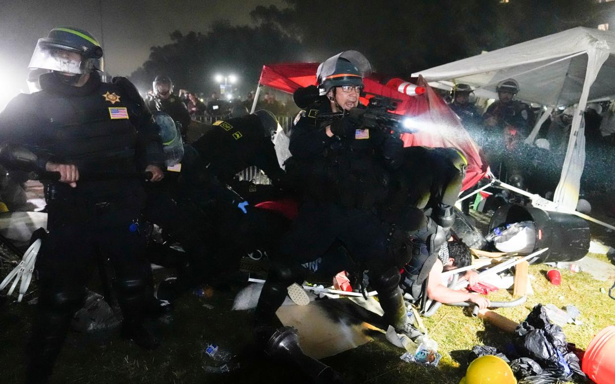 Police advance on pro-Palestinian demonstrators in an encampment on the UCLA campus