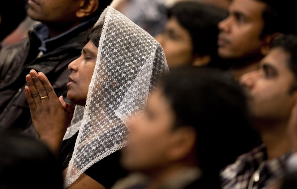 A woman wears a veil as she prays during a mass for the Sri Lankan community, in St. Peter's Basilica at the Vatican, Saturday, Feb. 8, 2014. (AP Photo/Alessandra Tarantino)