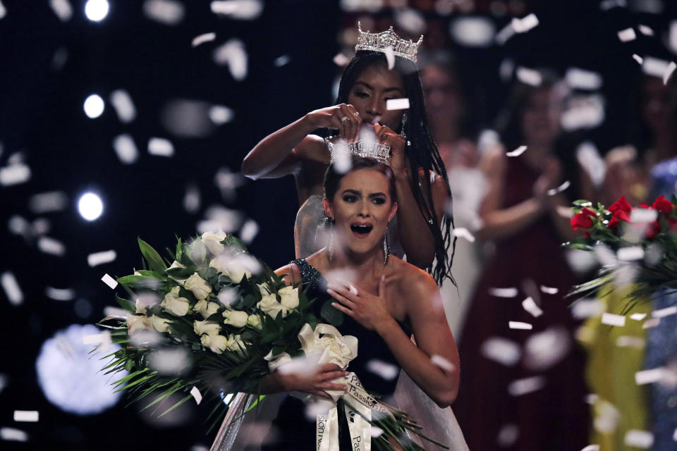 Camille Schrier, of Virginia, reacts as she is crowned after winning the Miss America competition at the Mohegan Sun casino in Uncasville, Conn., Thursday, Dec. 19, 2019. At rear is 2019 Miss America Nia Franklin. (AP Photo/Charles Krupa)