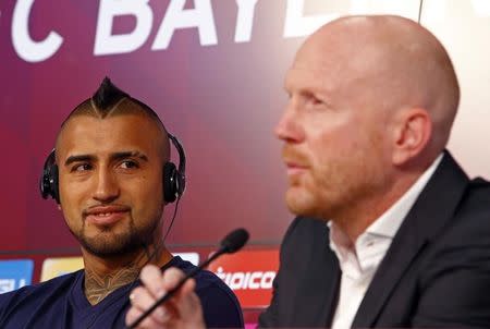 Chile's Arturo Vidal, Bayern Munich's new signing, looks on as he is introduced to media by sporting director Matthias Sammer (R) at the Allianz Arena in Munich, Germany July 28, 2015. REUTERS/Michaela Rehle