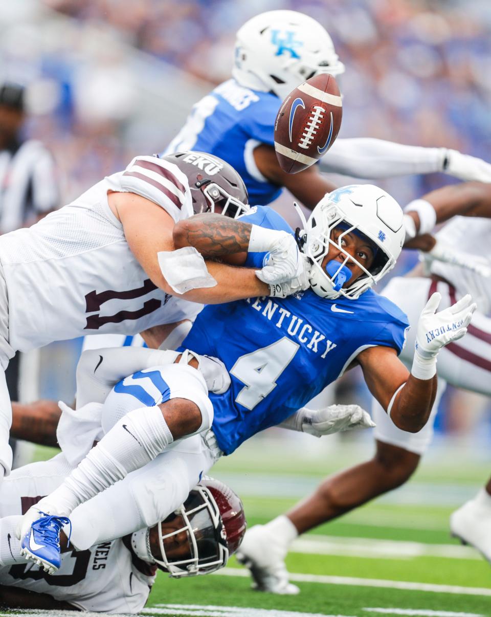 Kentucky Wildcats running back JuTahn McClain (4) fumbles during a run against Eastern Kentucky but managed to recover the ball in the first half of UK's win on Sept. 9, 2023. This photo earned APSE honors in the action photo category.