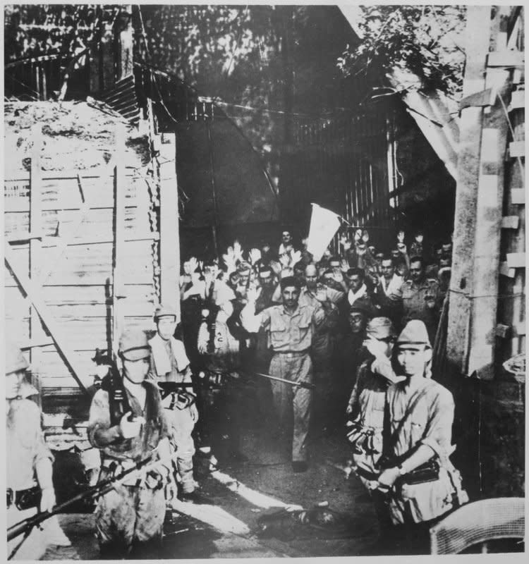 U.S. troops surrender to the Japanese at Corregidor, Philippines, on May 6, 1942, one day after an attack by the latter. File Photo courtesy of the U.S. National Archives and Records Administration