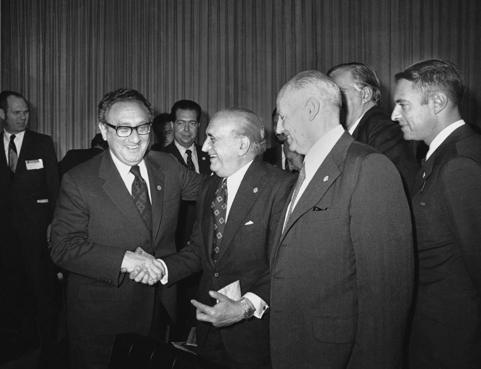 FILE - U.S. Secretary of State Henry Kissinger greets Argentina's Foreign Minister, Alberto J. Vignes, as Ismael Huerta Diaz, right, foreign ministers of Chile, looks on during break in Latin Foreign Ministers Conference in Mexico City, Feb. 22, 1974. Leftists in Chile were tortured during the military dictatorship of Gen. Augusto Pinochet and in Argentina, many were "disappeared" by members of the brutal military dictatorship that held detainees in concentration camps. It all happened with the endorsement of Henry Kissinger, the former U.S. secretary of state. Many countries were scarred deeply during the Cold War by human rights abuses inflicted in the name of anti-communism and where many still harbor a deep distrust of their powerful neighbor to the north. (AP Photo/Ed Kolenovsky, File)