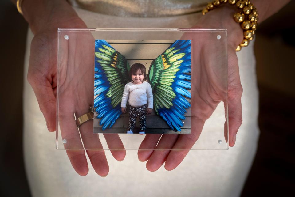 Maria Villegas holds a photograph of her daughter, Mia, who died from brain cancer in 2021. In her honor, they created Mia's Miracles to provide support to children and families facing challenging circumstances.