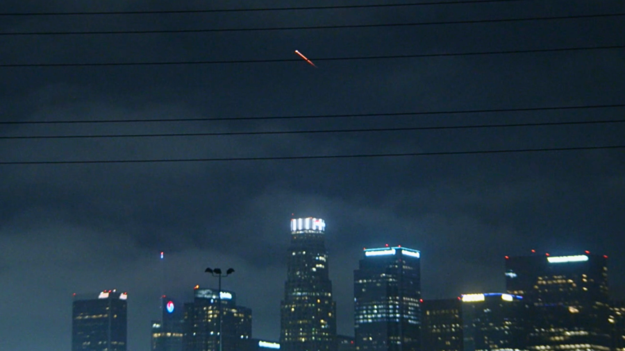 A SpaceX Falcon 9 rocket is seen over the downtown Los Angeles skyline on May 22, 2024.