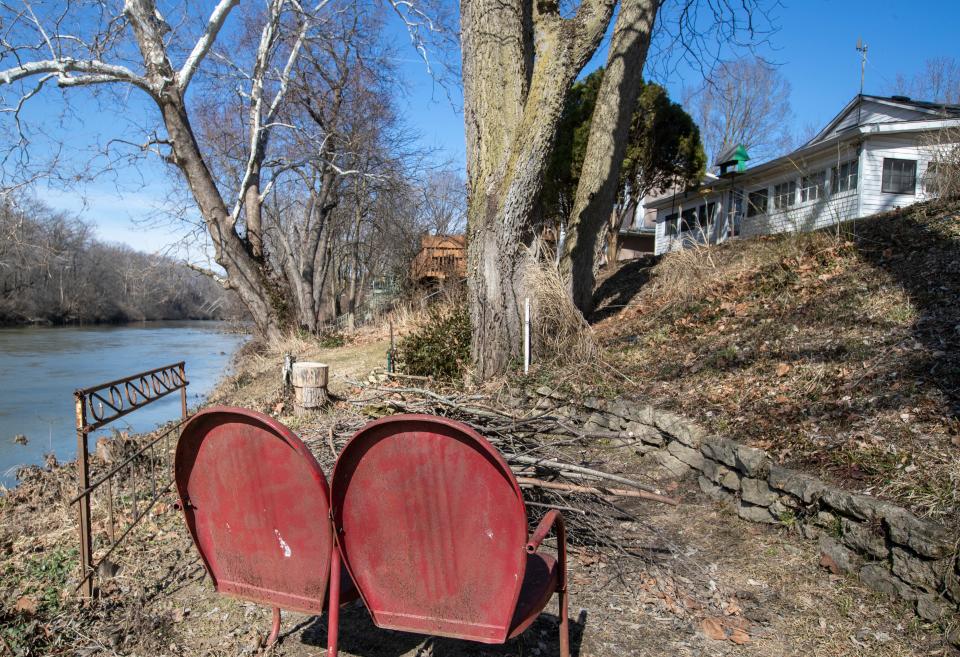 Chairs and waterfront in the Rocky Ripple neighborhood, Indianapolis, Tuesday, March 1, 2022, amid a current plan by the city to demolish 14 homes to make way for a proposed levee along the White River. 