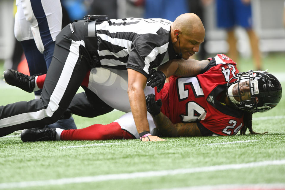 A referee had to wrestle the Falcons' Devonta Freeman to the ground after he got into a heated altercation with the Rams' Aaron Donald. (AP Photo/John Amis)