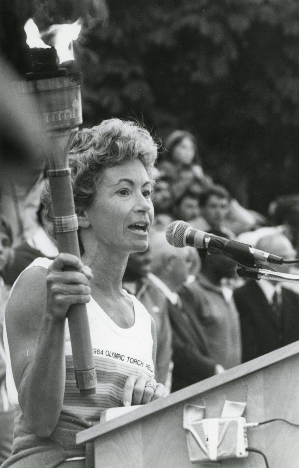 Honey Alexander gives a brief speech at UT's Circle Park after passing the torch to another runner in May 1984. 