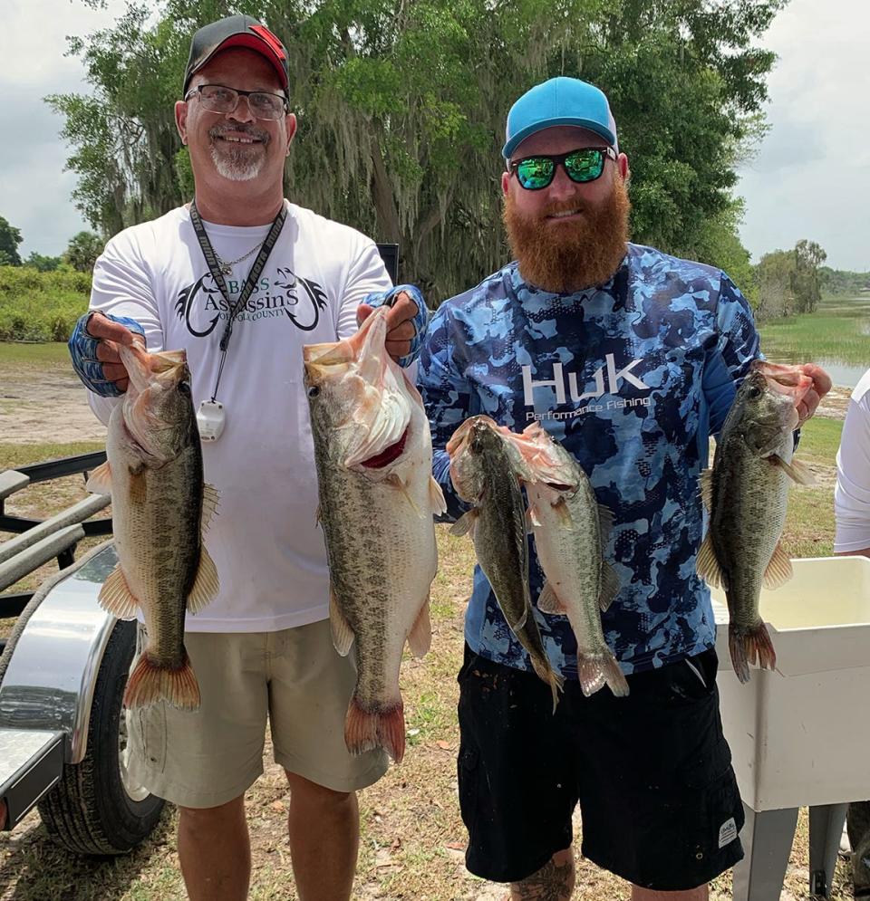 Jimmy Saxon, left, and Wade Bess placed second with 17.14 pounds and also had big bass with a 6.86 pounder during the Polk County Bass AssassinÕs tournament May 21 on Lake Alfred. 