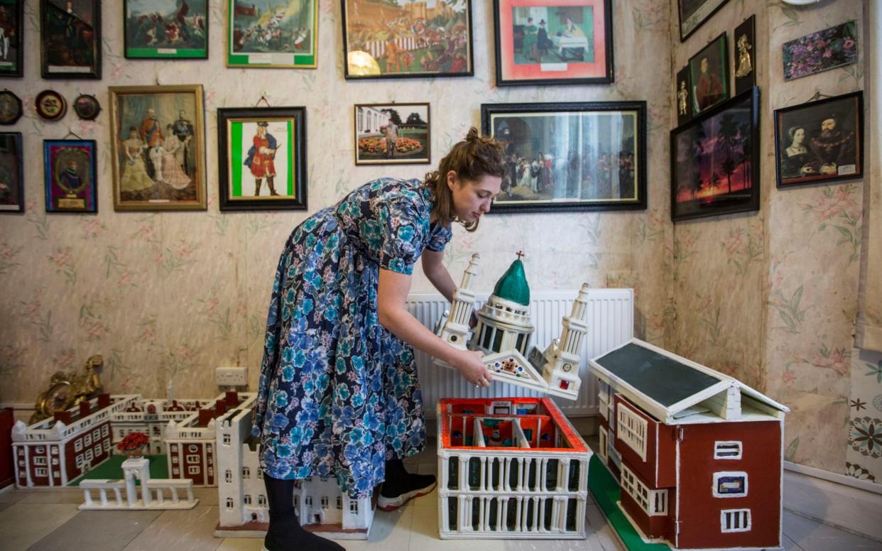 Sasha Galitzine, a curator, places the roof back onto the model of St Paul's Cathedral  - Jeff Gilbert /Jeff Gilbert 