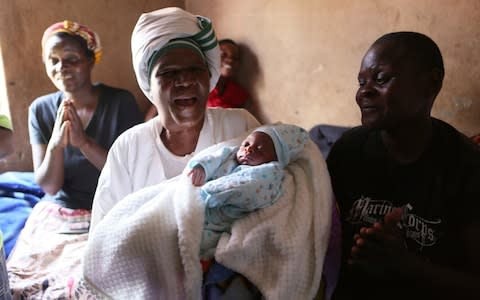 Esther Zinyoro Gwena has become a local hero delivering babies in her tiny Harare apartment for mothers-to-be abandoned by medical facilities forced to close in Zimbabwe's economic crisis - Credit: Tsvangirayi Mukwazhi/AP