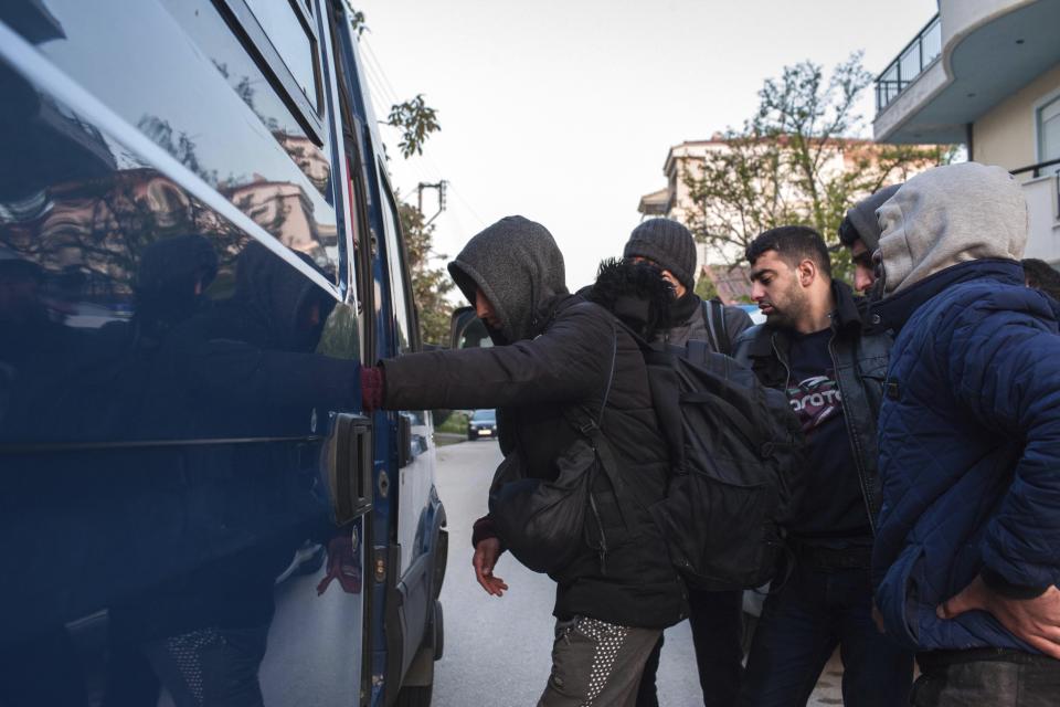 Migrants from Syria and Iraq wanting to register for asylum, embark a police bus in Orestiada town, northeastern Greece, Monday, April 22, 2019. Greek authorities say dozens of asylum-seekers have turned up at the front door of European border agency employees helping police Greece's northeastern border with Turkey. (AP Photo/Antonis Pasvantis)