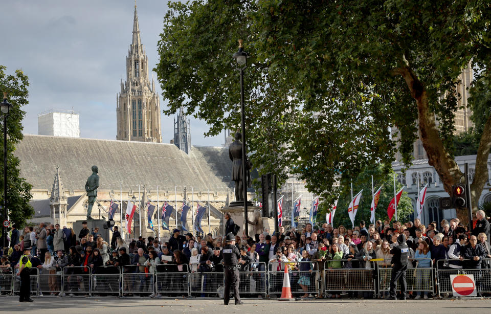 Numerous people wait at a crossroads outside the Palace of Westminster to catch a glimpse of the arriving state guests who want to visit the laid out coffin of Queen Elizabeth II in Westminster Hall.  / Credit: Christian Charisius/picture alliance/Getty Images