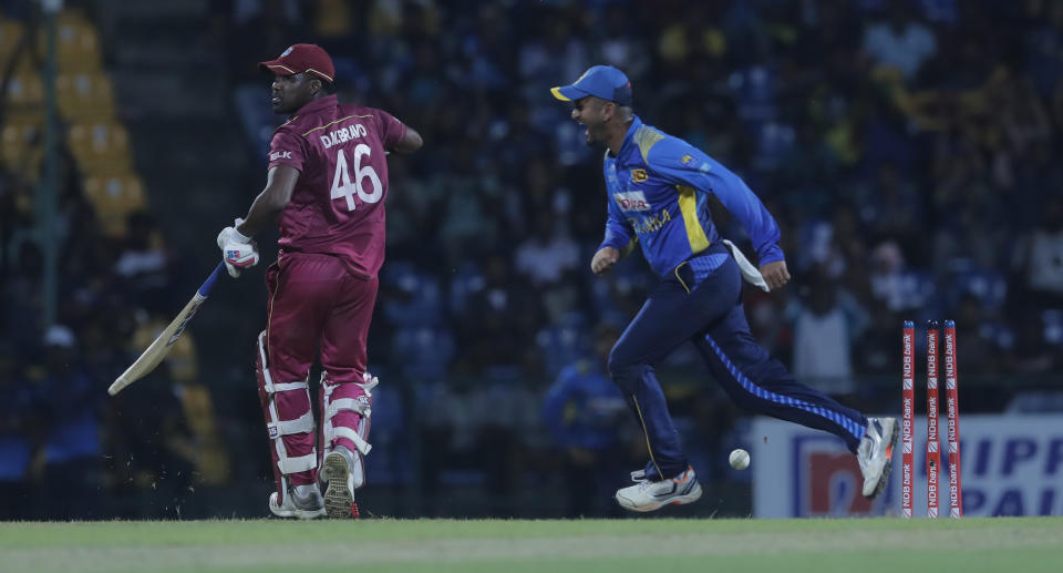 Sri Lanka's Dimuth Karunaratne, right, celebrates the dismissal of West Indies' Darren Bravo during the third one day international cricket match between Sri Lanka and West Indies in Pallekele, Sri Lanka, Sunday, March 1, 2020. (AP Photo/Eranga Jayawardena)