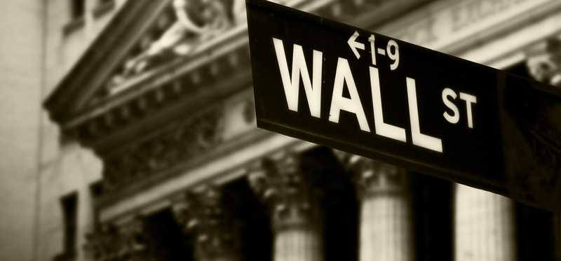 A close up black and white photo of the Wall street sign.