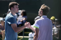 Jack Draper, of Britain, left, shakes hands with Leandro Riedi, of Switzerland, at the BNP Paribas Open tennis tournament Thursday, March 9, 2023, in Indian Wells, Calif. (AP Photo/Mark J. Terrill)