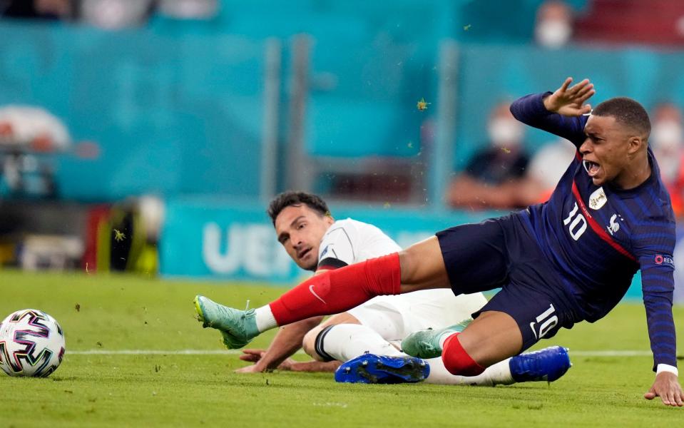 France's Kylian Mbappe, right, and Germany's Mats Hummels battle for the ball during the Euro 2020 soccer championship group F match between France and Germany at the Allianz Arena in Munich, Germany, Tuesday, June 15, 202 - AP Photo/Matthias Schrader, Pool)