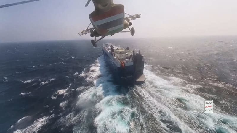 A handout photo, made available on 21 November 2023, by the Houthi Military Media Center, depicts Houthi helicopter flying over the cargo ship 'Galaxy Leader' as they seize it in the Red Sea off the coast of Hodeidah. International Energy Agency said that the Red Sea disturbances cause a rise in demand for ship fuel. -/dpa