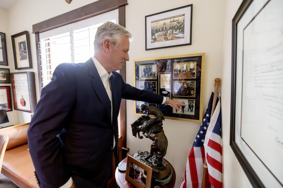 Former national security adviser to President Donald Trump and potential candidate for U.S. Senate Robert C. O’Brien points to several photos of him during his service, after doing an interview at his home in the Greater Salt Lake area on Tuesday, July 18, 2023. | Scott G Winterton, Deseret News