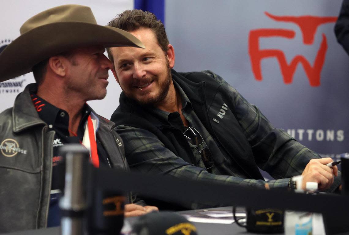 ‘Yellowstone’ actor Cole Hauser, right, leans in to take to screenwriter Taylor Sheridan while signing autographs at the Fort Worth Stock Show & Rodeo on Tuesday, February 1, 2022.
