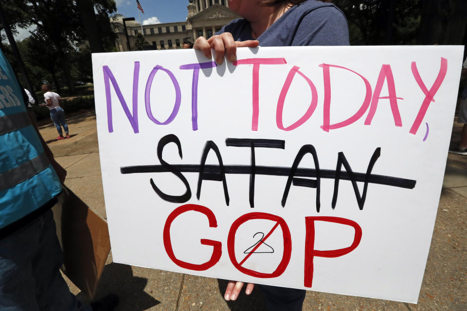 FILE - In this May 21, 2019, file photo, an abortion rights advocate holds signage at the Capitol in Jackson, Miss., voicing her opposition to state legislatures passing abortion bans that prohibit most abortions once a fetal heartbeat can be detected. The Supreme Court has agreed to hear a potentially ground-breaking abortion case, and the news is energizing activists on both sides of the contentious issue. They're already girding to make abortion access a high-profile issue in next year’s midterm elections. (AP Photo/Rogelio V. Solis, File)