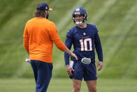 Denver Broncos quarterback Bo Nix, right, confers with quarterback coach Davis Webb, left while taking part in a drill during an NFL football rookie minicamp practice Saturday, May 11, 2024, in Centennial, Colo. (AP Photo/David Zalubowski)