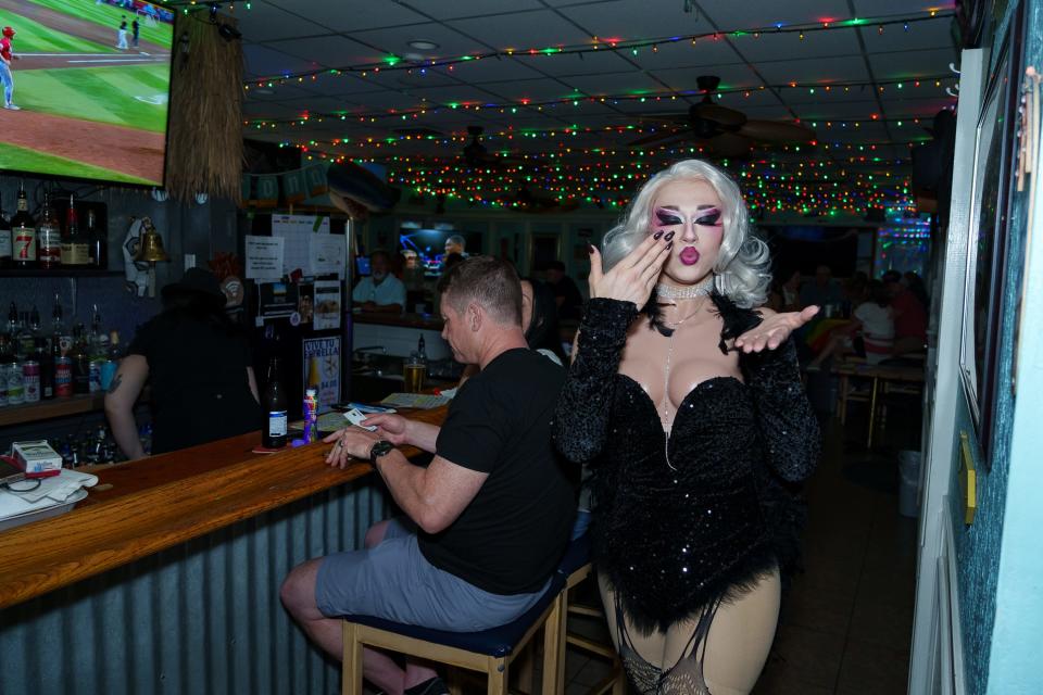 Esme Nichols, 18-year-old drag queen "Esme Adore", blows kisses to the camera as she helps host drag bingo at Playa II in Phoenix on Aug. 26, 2023.