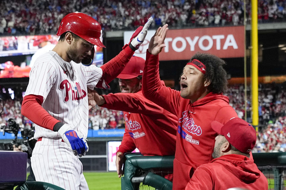 Philadelphia Phillies' Trea Turner celebrates in the dugout after a home run against the Arizona Diamondbacks during the first inning in Game 2 of the baseball NL Championship Series in Philadelphia, Tuesday, Oct. 17, 2023. (AP Photo/Brynn Anderson)