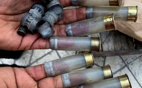 An Iranian protester shows the bullets shot by security forces during protests in Tehran, Iran  - Credit: REX