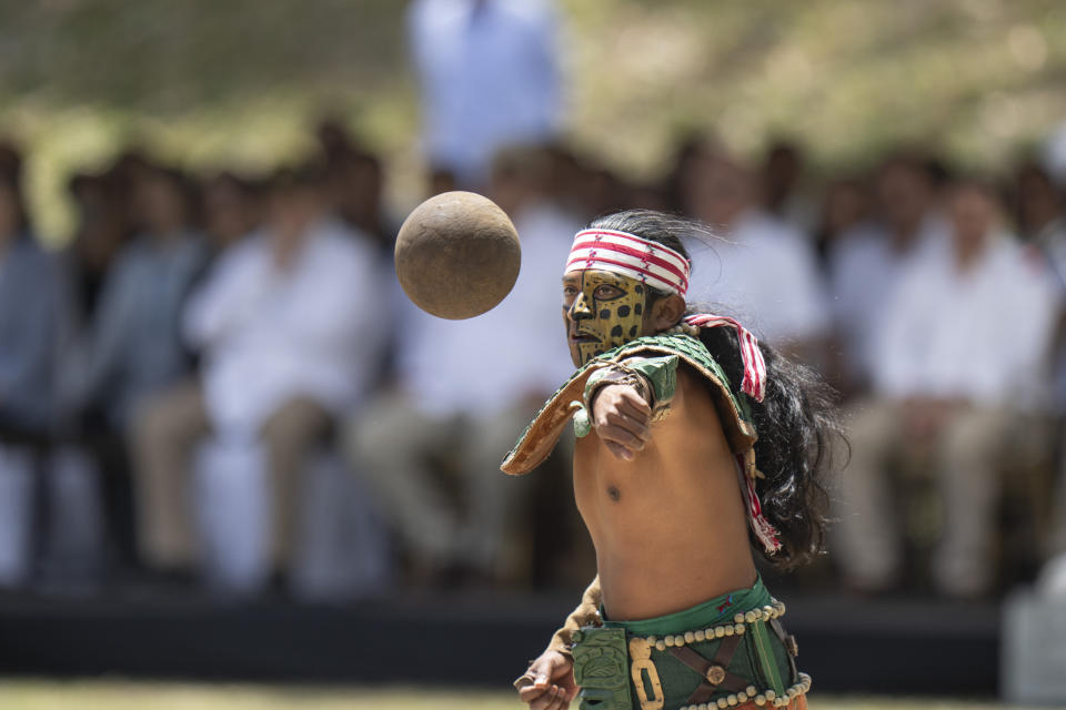 An artist performs as a player of "pelota Maya" during a visit by Taiwan's President Tsai Ing-wen and Guatemala's President Alejandro Giammattei, to the Mayan site Tikal, in Peten, Guatemala, Saturday, April 1, 2023. Tsai is in Guatemala for an official three-day visit. (AP Photo/Moises Castillo)