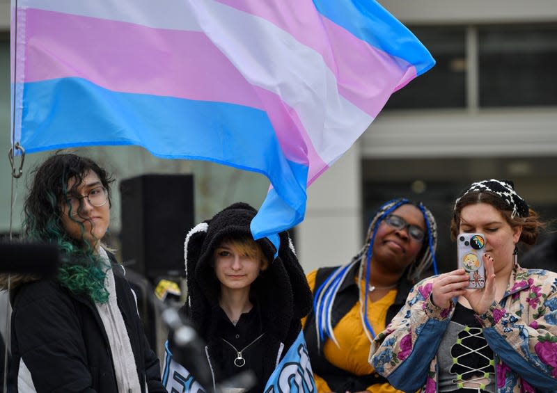 WILKES-BARRE, PENNSYLVANIA, UNITED STATES - 2023/03/31: Members of the Gender Sexuality Alliance stand under the Transgender flag at a ceremony and flag raising for Transgender day of Visibility. March 31, is the Transgender Day of Visibility a day meant to raise awareness of discrimination of Transgender people and celebrate transgender people.