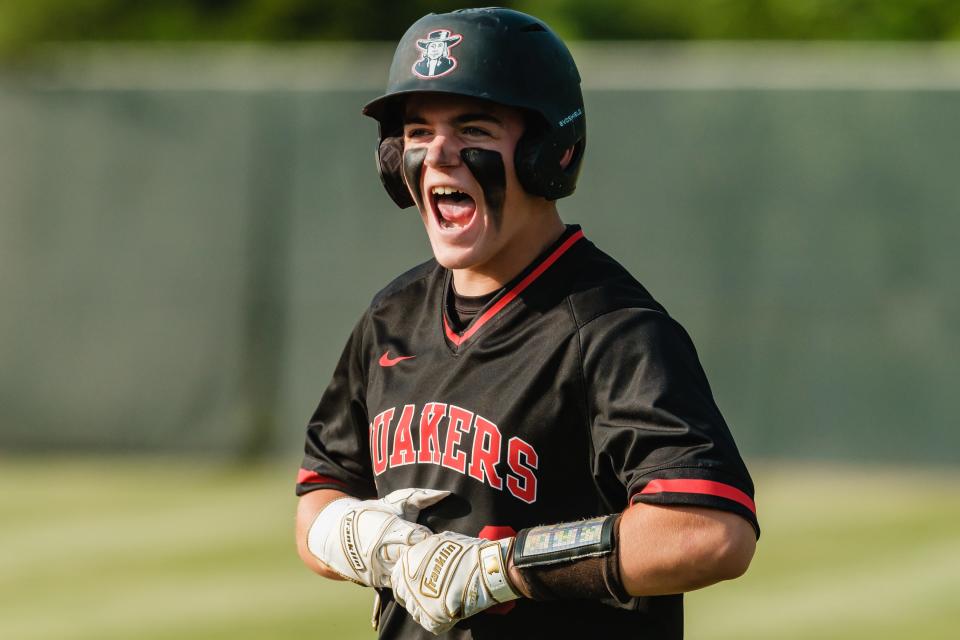 New Philadelphia's Noah Bollon celebrates during a Division II district final against Tri Valley, Wednesday, May 24, at Coshocton Lake Park.