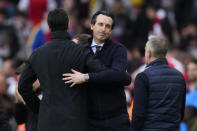 Aston Villa's head coach Unai Emery, right, hugs Arsenal's manager Mikel Arteta after the English Premier League soccer match between Arsenal and Aston Villa at the Emirates stadium in London, Sunday, April 14, 2024. (AP Photo/Kirsty Wigglesworth)