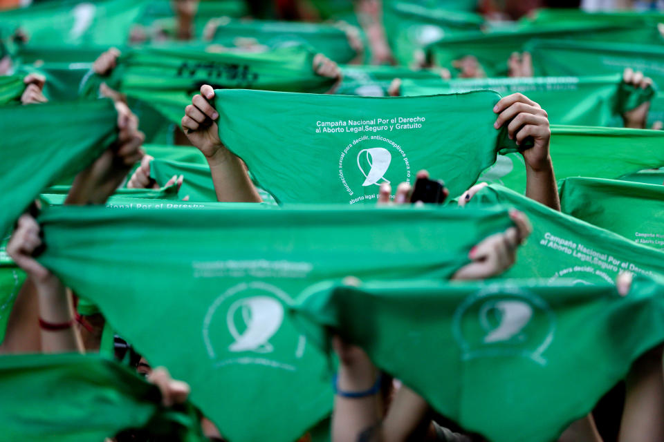 FILE - In this April 10, 2018, file photo, abortion-rights demonstrators raise green handkerchiefs during a rally in front of the National Congress in Buenos Aires, Argentina. The homeland of Pope Francis was closer than ever this year to legalizing abortion after a wave of demonstrations by women’s rights groups and shifting public opinion. The demonstrators staged wide protests in the streets of Argentina wearing green handkerchiefs that symbolize the abortion rights movement. (AP Photo/Natacha Pisarenko, File)