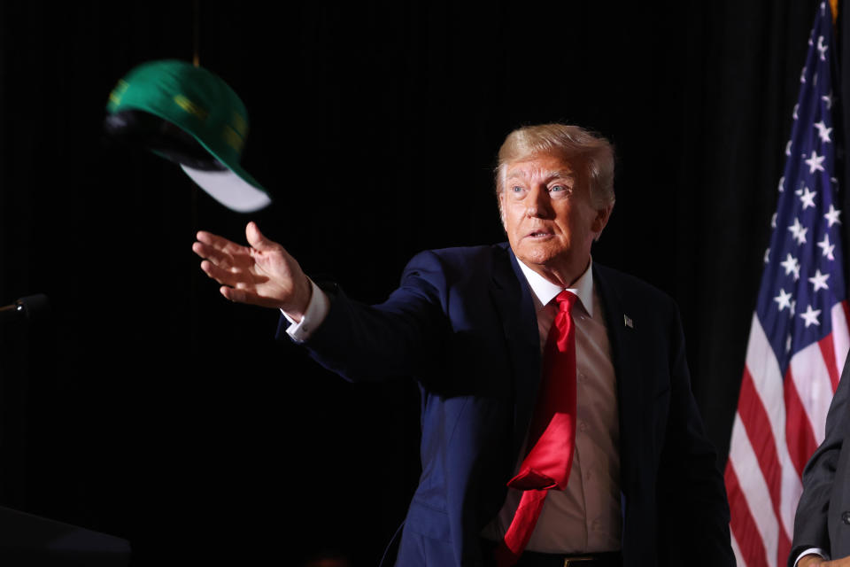 COUNCIL BLUFFS, IOWA - JULY 07: Former U.S. President Donald Trump tosses hats to supporters as he arrives for a Farmers for Trump campaign event at the MidAmerica Center on July 07, 2023 in Council Bluffs, Iowa.  / Credit: Scott Olson / Getty Images