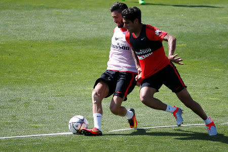 Football Soccer - Atletico Madrid training - Majadahonda, Spain -21/5/16- Atletico Madrid's Yannick Carrasco (L) and Augusto Fernandez attend a training session in Majadahonda. REUTERS/Juan Medina