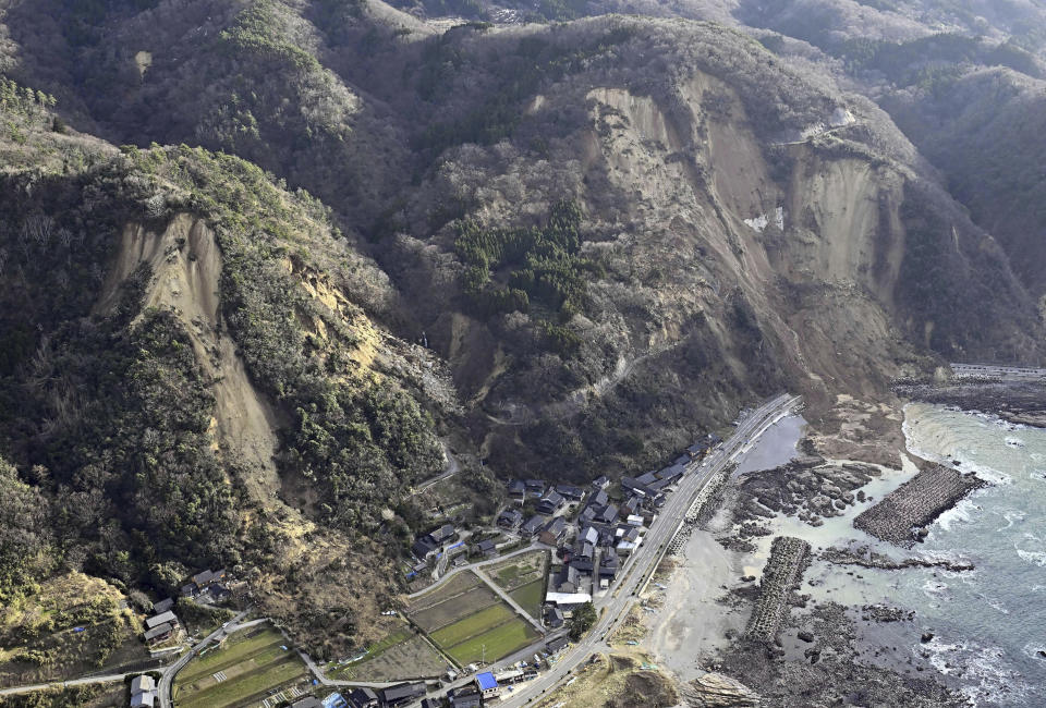 This aerial photo shows a national road is blocked by landslides caused by earthquakes in Suzu, Ishikawa prefecture, Japan Thursday, Jan. 4, 2024. More soldiers have been ordered to bolster the rescue operations Thursday, providing those in need with drinking water, hot meals and setting up bathing facilities after a magnitude 7.6 quake hit Ishikawa Prefecture and nearby regions Monday. (Kyodo News via AP)