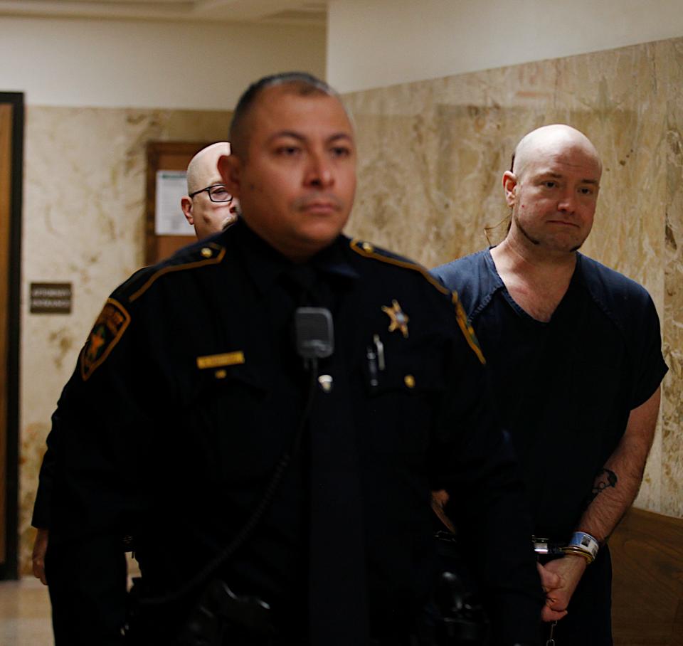 Kethan Anderson, 42, is escorted out of the 364th District Court where he was sentenced to 50  years in prison for strangling a man to death more than three years ago at a condemned home in central Lubbock.