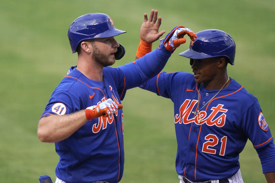 New York Mets' Pete Alonso, left, is greeted by Mallex Smith (21) after hitting a grand slam during the fifth inning of a spring training baseball game against the Washington Nationals, Thursday, March 4, 2021, in Port St. Lucie, Fla. (AP Photo/Lynne Sladky)