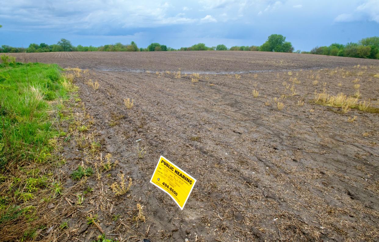 A sign for a Planning and Zoning Commission public hearing stands in a field at the end of Service Drive No. 2 off Knoxville Avenue in North Peoria. The commission approved a plan to develop an 86-acre plot of land between Knoxville and Allen Road into a new subdivision.