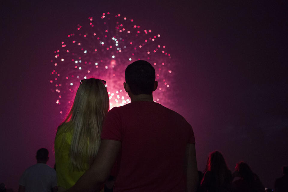 <p>A couple enjoys the fireworks at the Washington Monument in Washington D.C. on July 4, 2017. (Calla Kessler/The Washington Post via Getty Images) </p>