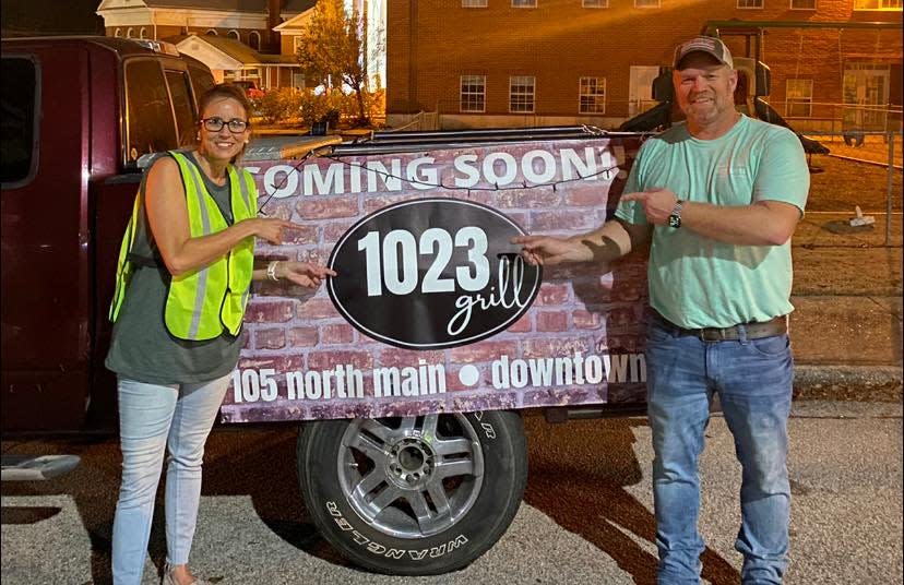 Grace and Brad Waits show off the sign for their new restaurant, 1023 Grill, that was announced during the Screven County Chamber of Commerce's Christmas Extravaganza in Sylvania on Dec. 11.