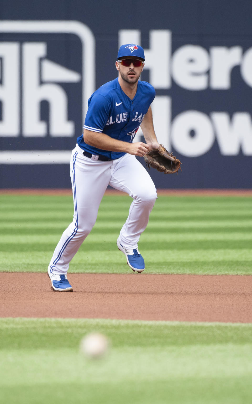 Toronto Blue Jays shortstop Paul DeJong tracks a ground ball off the bat of Chicago Cubs' Ian Happ in first-inning baseball game action in Toronto, Sunday, Aug. 13, 2023. (Jon Blacker/The Canadian Press via AP)